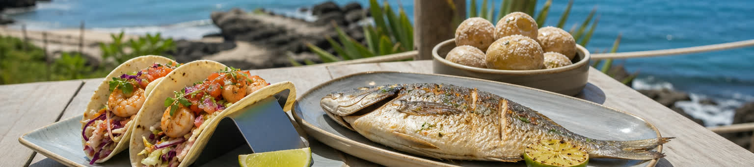 Shrimp tacos, grilled fish, papas arrugadas, lime, and coastal seafood plates by the ocean.