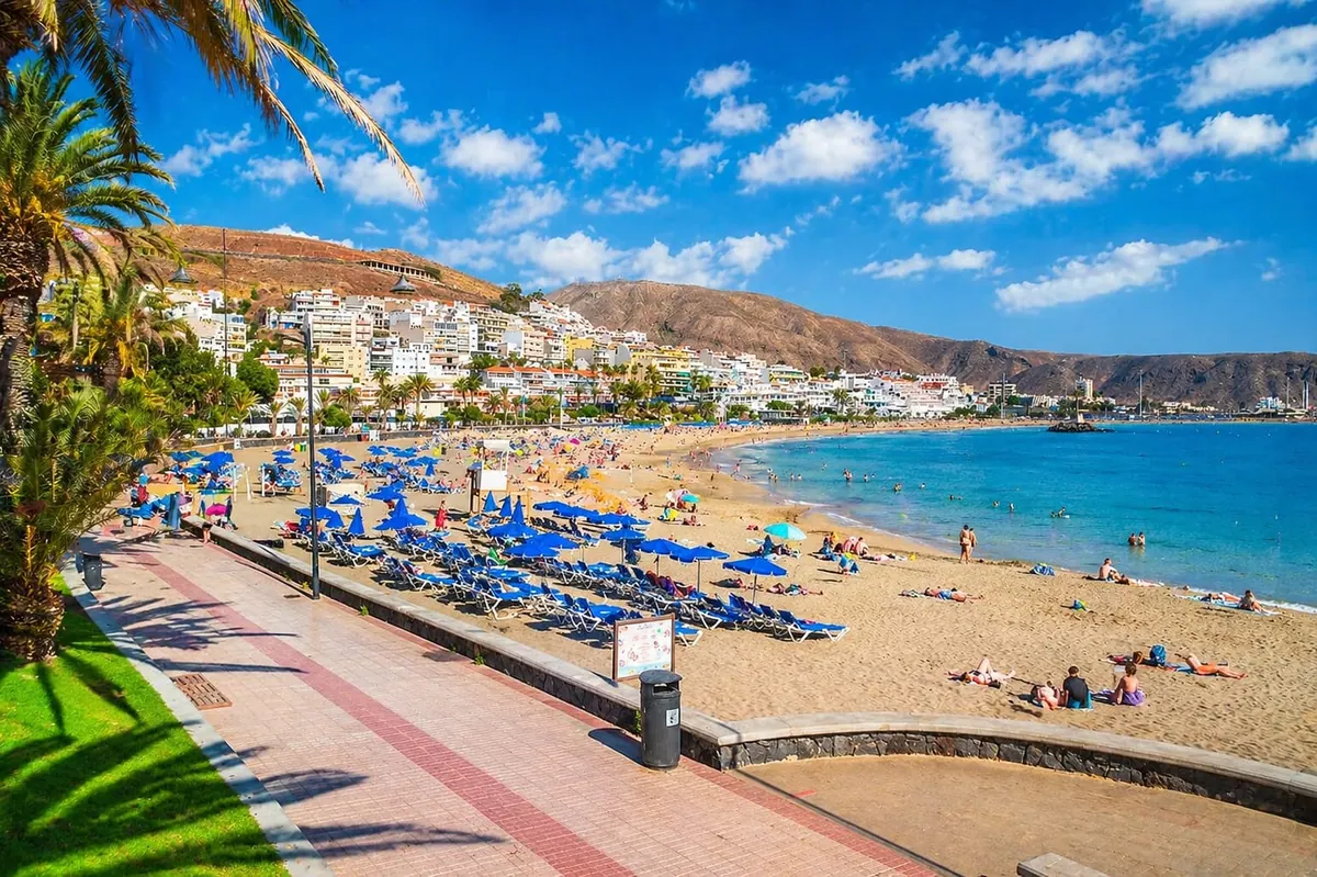 View of Playa de Las Vistas with golden sand and calm water.