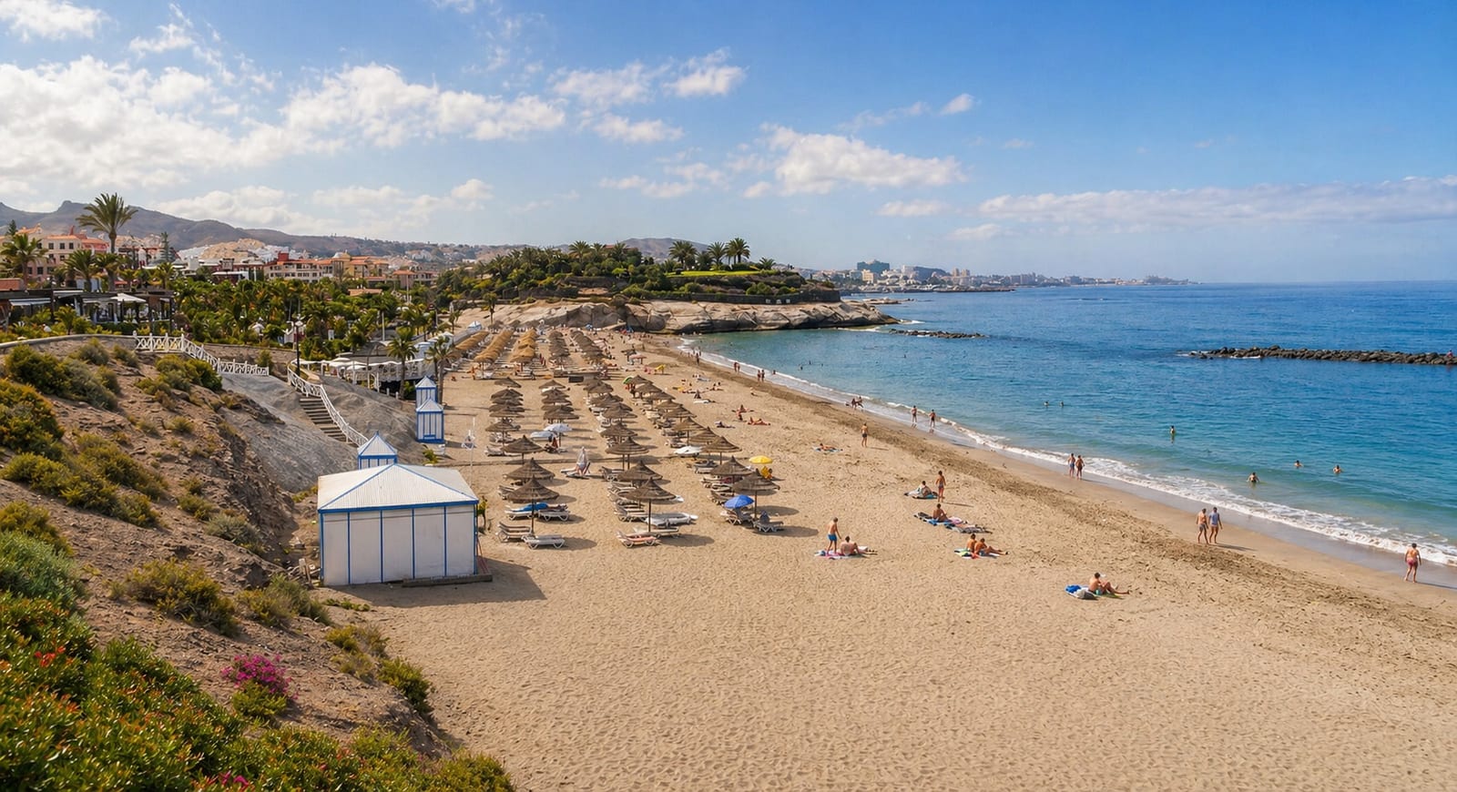 View of Playa del Duque with pale sand and resort coastline.