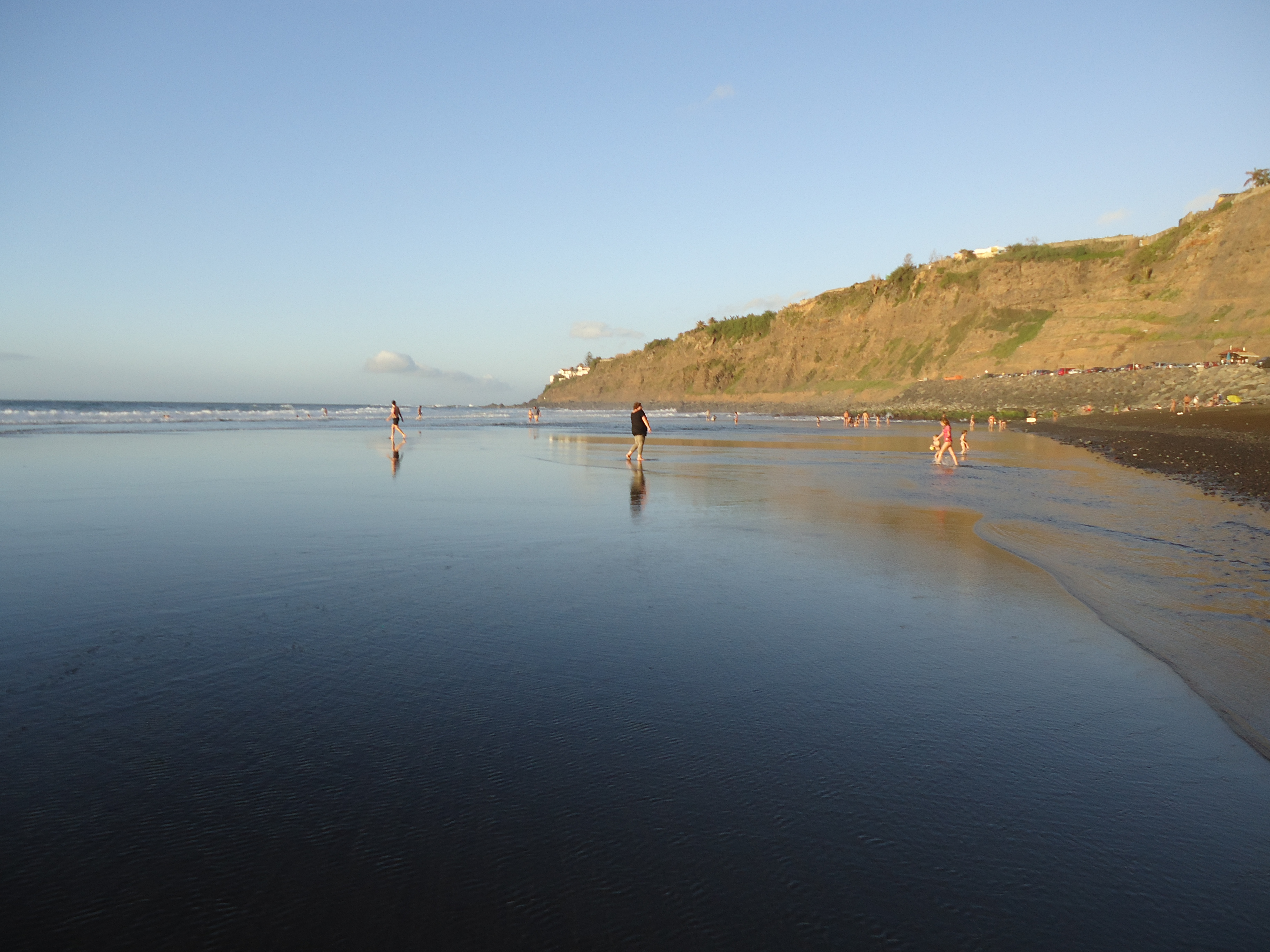 Black-sand Playa de El Socorro below the green north coast cliffs of Los Realejos.