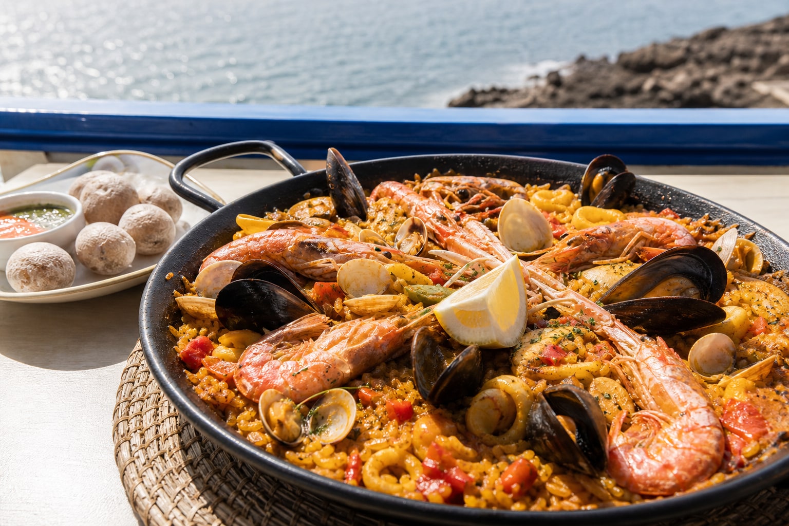 Seafood paella with prawns, mussels, clams, lemon, and papas arrugadas.