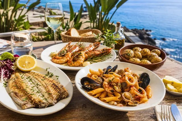 Italian seafood and pasta plates on a sunny Tenerife terrace